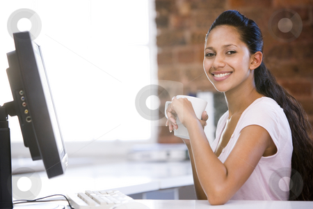 To use this stock image in your creative project, please select the size you need over to the right and click the "Add to Cart" button.
Your downloaded image will come with the Cutcaster watermark removed so don’t worry about the watermark you see on this page. Businesswoman in office drinking coffee and smiling stock photo, by Monkey Business Images