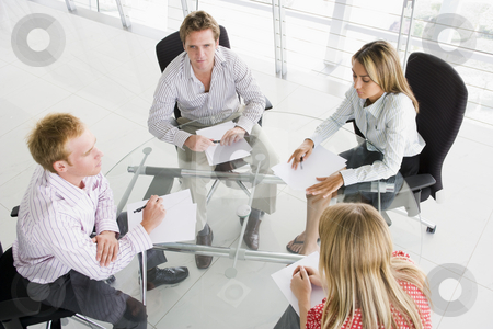 To use this stock image in your creative project, please select the size you need over to the right and click the "Add to Cart" button.
Your downloaded image will come with the Cutcaster watermark removed so don’t worry about the watermark you see on this page. Four businesspeople in boardroom with paperwork stock photo, by Monkey Business Images