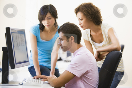 To use this stock image in your creative project, please select the size you need over to the right and click the "Add to Cart" button.
Your downloaded image will come with the Cutcaster watermark removed so don’t worry about the watermark you see on this page. Three people sitting in computer room looking at monitor stock photo, by Monkey Business Images