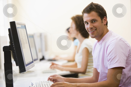 To use this stock image in your creative project, please select the size you need over to the right and click the "Add to Cart" button.
Your downloaded image will come with the Cutcaster watermark removed so don’t worry about the watermark you see on this page. Three people sitting in computer room typing and smiling stock photo, by Monkey Business Images
