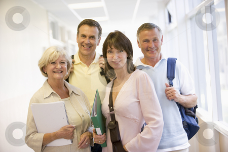 To use this stock image in your creative project, please select the size you need over to the right and click the "Add to Cart" button.
Your downloaded image will come with the Cutcaster watermark removed so don’t worry about the watermark you see on this page. A group of adult students with backpacks standing in a campus co stock photo, by Monkey Business Images