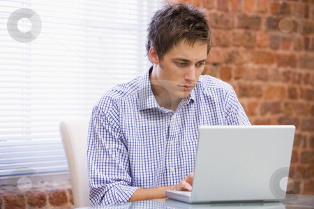 To use this stock image in your creative project, please select the size you need over to the right and click the "Add to Cart" button.
Your downloaded image will come with the Cutcaster watermark removed so don’t worry about the watermark you see on this page. Businessman in office typing on laptop stock photo, by Monkey Business Images