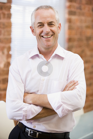 To use this stock image in your creative project, please select the size you need over to the right and click the "Add to Cart" button.
Your downloaded image will come with the Cutcaster watermark removed so don’t worry about the watermark you see on this page. Businessman standing in office laughing stock photo, by Monkey Business Images