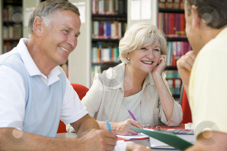 To use this stock image in your creative project, please select the size you need over to the right and click the "Add to Cart" button.
Your downloaded image will come with the Cutcaster watermark removed so don’t worry about the watermark you see on this page. Adult students working together in a library stock photo, by Monkey Business Images