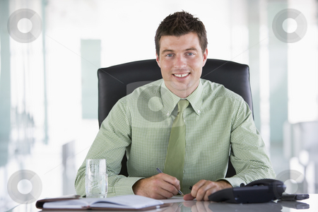 To use this stock image in your creative project, please select the size you need over to the right and click the "Add to Cart" button.
Your downloaded image will come with the Cutcaster watermark removed so don’t worry about the watermark you see on this page. Businessman sitting in office with personal organizer smiling stock photo, by Monkey Business Images