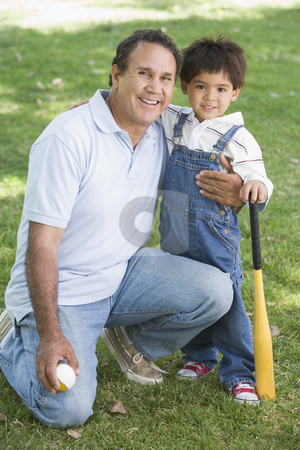 To use this stock image in your creative project, please select the size you need over to the right and click the "Add to Cart" button.
Your downloaded image will come with the Cutcaster watermark removed so don’t worry about the watermark you see on this page. Grandfather and grandson holding baseball bat and smiling stock photo, by Monkey Business Images