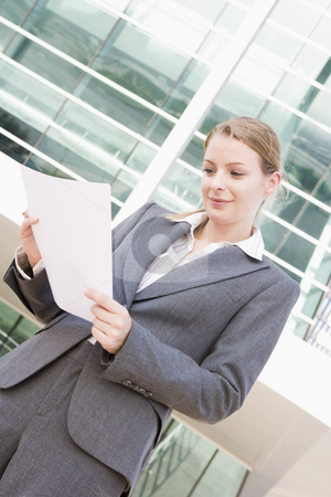 To use this stock image in your creative project, please select the size you need over to the right and click the "Add to Cart" button.
Your downloaded image will come with the Cutcaster watermark removed so don’t worry about the watermark you see on this page. Businesswoman standing outdoors reading paperwork stock photo, by Monkey Business Images