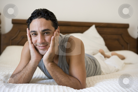 To use this stock image in your creative project, please select the size you need over to the right and click the "Add to Cart" button.
Your downloaded image will come with the Cutcaster watermark removed so don’t worry about the watermark you see on this page. A Middle Eastern man lying on a bed stock photo, by Monkey Business Images