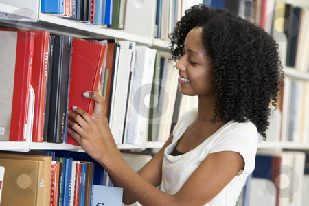 To use this stock image in your creative project, please select the size you need over to the right and click the "Add to Cart" button.
Your downloaded image will come with the Cutcaster watermark removed so don’t worry about the watermark you see on this page. University student working in library stock photo, Female university student selecting library book from shelf by Monkey Business Images