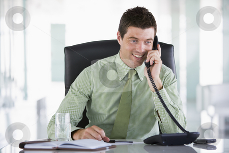 To use this stock image in your creative project, please select the size you need over to the right and click the "Add to Cart" button.
Your downloaded image will come with the Cutcaster watermark removed so don’t worry about the watermark you see on this page. Businessman sitting in office with personal organizer on telepho stock photo, by Monkey Business Images