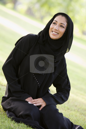 To use this stock image in your creative project, please select the size you need over to the right and click the "Add to Cart" button.
Your downloaded image will come with the Cutcaster watermark removed so don’t worry about the watermark you see on this page. A Middle Eastern woman sitting in a park stock photo, by Monkey Business Images