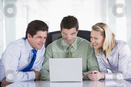 To use this stock image in your creative project, please select the size you need over to the right and click the "Add to Cart" button.
Your downloaded image will come with the Cutcaster watermark removed so don’t worry about the watermark you see on this page. Three businesspeople in office with laptop smiling stock photo, by Monkey Business Images