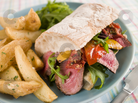 To use this stock image in your creative project, please select the size you need over to the right and click the "Add to Cart" button.
Your downloaded image will come with the Cutcaster watermark removed so don’t worry about the watermark you see on this page. Steak and Roasted Pepper Ciabatta Sandwich with Spiced Potato We stock photo, Plate of Steak and Roasted Pepper Ciabatta Sandwich with Spiced Potato Wedges by Monkey Business Images