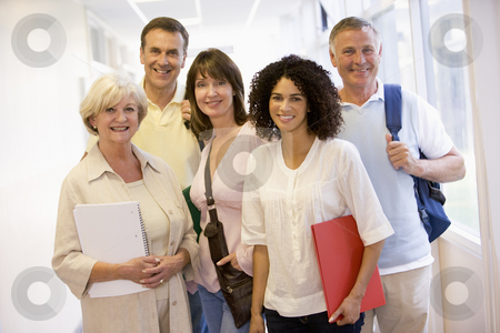 To use this stock image in your creative project, please select the size you need over to the right and click the "Add to Cart" button.
Your downloaded image will come with the Cutcaster watermark removed so don’t worry about the watermark you see on this page. A group of adult students with backpacks standing in a campus co stock photo, by Monkey Business Images