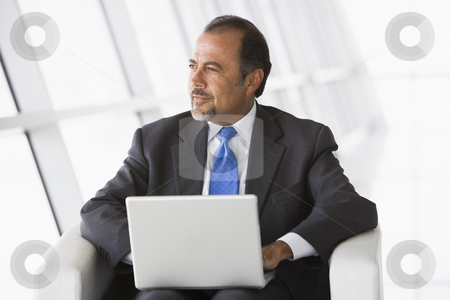 To use this stock image in your creative project, please select the size you need over to the right and click the "Add to Cart" button.
Your downloaded image will come with the Cutcaster watermark removed so don’t worry about the watermark you see on this page. Businessman using laptop in lobby stock photo, Businessman using laptop in office lobby by Monkey Business Images