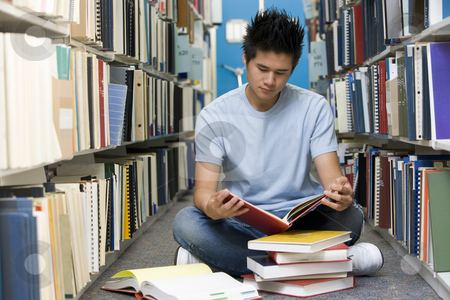 To use this stock image in your creative project, please select the size you need over to the right and click the "Add to Cart" button.
Your downloaded image will come with the Cutcaster watermark removed so don’t worry about the watermark you see on this page. University student working in library stock photo, Male university student sitting on library floor surrounded by books by Monkey Business Images