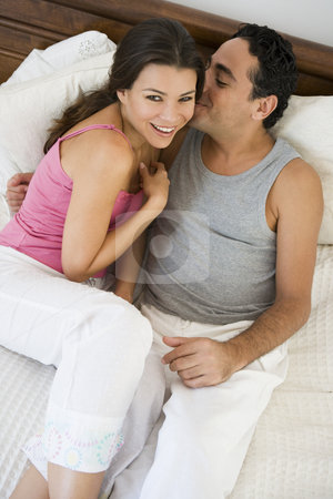 To use this stock image in your creative project, please select the size you need over to the right and click the "Add to Cart" button.
Your downloaded image will come with the Cutcaster watermark removed so don’t worry about the watermark you see on this page. A Middle Eastern couple lying on a bed stock photo, by Monkey Business Images