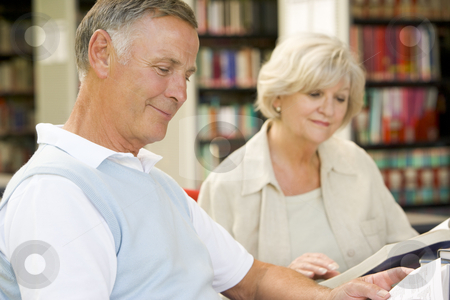 To use this stock image in your creative project, please select the size you need over to the right and click the "Add to Cart" button.
Your downloaded image will come with the Cutcaster watermark removed so don’t worry about the watermark you see on this page. Adult students reading in a library stock photo, by Monkey Business Images