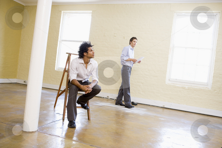 To use this stock image in your creative project, please select the size you need over to the right and click the "Add to Cart" button.
Your downloaded image will come with the Cutcaster watermark removed so don’t worry about the watermark you see on this page. Man sitting on ladder in empty space with another man holding pa stock photo, by Monkey Business Images