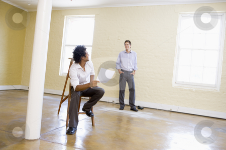 To use this stock image in your creative project, please select the size you need over to the right and click the "Add to Cart" button.
Your downloaded image will come with the Cutcaster watermark removed so don’t worry about the watermark you see on this page. Man sitting on ladder in empty space holding paper talking to ot stock photo, by Monkey Business Images