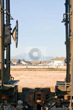 To use this stock image in your creative project, please select the size you need over to the right and click the "Add to Cart" button.
Your downloaded image will come with the Cutcaster watermark removed so don’t worry about the watermark you see on this page. Housing development between mountains and rail-road stock photo, A view of the mountains from between railcars by RCarner Photography