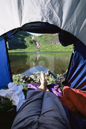To use this stock image in your creative project, please select the size you need over to the right and click the "Add to Cart" button.
Your downloaded image will come with the Cutcaster watermark removed so don’t worry about the watermark you see on this page. Woman lying in tent with a view of lake stock photo, by Monkey Business Images