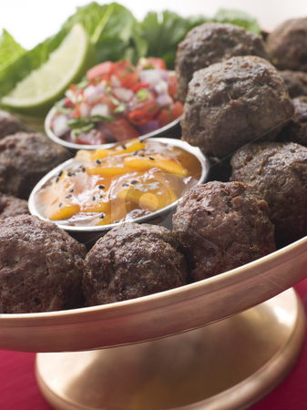 To use this stock image in your creative project, please select the size you need over to the right and click the "Add to Cart" button.
Your downloaded image will come with the Cutcaster watermark removed so don’t worry about the watermark you see on this page. Platter of Kofta Balls with Mango Chutney and Tomato Relish stock photo, by Monkey Business Images