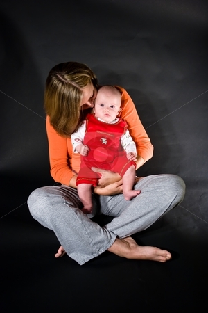 To use this stock image in your creative project, please select the size you need over to the right and click the "Add to Cart" button.
Your downloaded image will come with the Cutcaster watermark removed so don’t worry about the watermark you see on this page. Mother and baby girl stock photo, Baby caucasian girl sitting on mother's lap by Mariusz Jurgielewicz