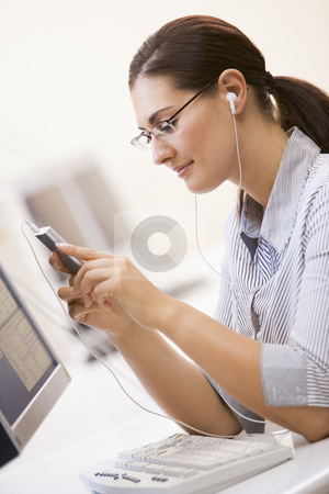 To use this stock image in your creative project, please select the size you need over to the right and click the "Add to Cart" button.
Your downloaded image will come with the Cutcaster watermark removed so don’t worry about the watermark you see on this page. Woman in computer room listening to MP3 Player stock photo, by Monkey Business Images