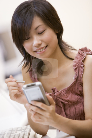To use this stock image in your creative project, please select the size you need over to the right and click the "Add to Cart" button.
Your downloaded image will come with the Cutcaster watermark removed so don’t worry about the watermark you see on this page. Woman in computer room using personal digital assistant smiling stock photo, by Monkey Business Images