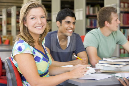 To use this stock image in your creative project, please select the size you need over to the right and click the "Add to Cart" button.
Your downloaded image will come with the Cutcaster watermark removed so don’t worry about the watermark you see on this page. College students studying together in a library stock photo, by Monkey Business Images