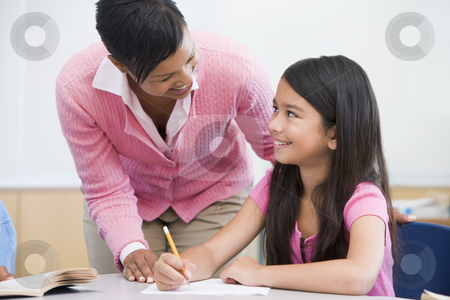 To use this stock image in your creative project, please select the size you need over to the right and click the "Add to Cart" button.
Your downloaded image will come with the Cutcaster watermark removed so don’t worry about the watermark you see on this page. Elementary school classroom stock photo, Teacher helping elementary school child with written project by Monkey Business Images