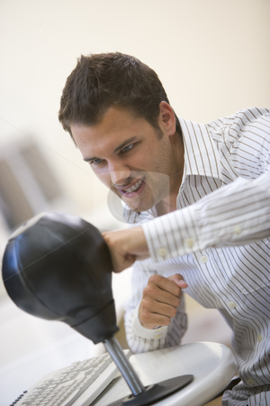 To use this stock image in your creative project, please select the size you need over to the right and click the "Add to Cart" button.
Your downloaded image will come with the Cutcaster watermark removed so don’t worry about the watermark you see on this page. Man sitting in computer room using small punching bag for stress stock photo, by Monkey Business Images
