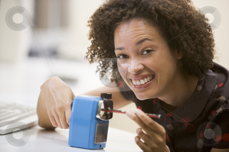 To use this stock image in your creative project, please select the size you need over to the right and click the "Add to Cart" button.
Your downloaded image will come with the Cutcaster watermark removed so don’t worry about the watermark you see on this page. Woman in computer room using pencil sharpener and smiling stock photo, by Monkey Business Images