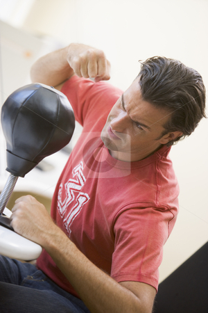 To use this stock image in your creative project, please select the size you need over to the right and click the "Add to Cart" button.
Your downloaded image will come with the Cutcaster watermark removed so don’t worry about the watermark you see on this page. Man indoors using small punching bag stock photo, by Monkey Business Images