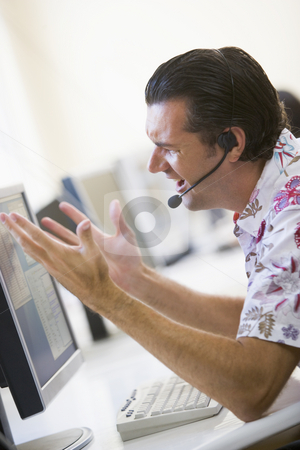 To use this stock image in your creative project, please select the size you need over to the right and click the "Add to Cart" button.
Your downloaded image will come with the Cutcaster watermark removed so don’t worry about the watermark you see on this page. Man in computer room wearing headset looking frustrated stock photo, by Monkey Business Images