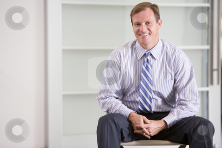 To use this stock image in your creative project, please select the size you need over to the right and click the "Add to Cart" button.
Your downloaded image will come with the Cutcaster watermark removed so don’t worry about the watermark you see on this page. Businessman sitting indoors smiling stock photo, by Monkey Business Images