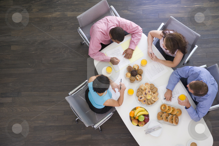 To use this stock image in your creative project, please select the size you need over to the right and click the "Add to Cart" button.
Your downloaded image will come with the Cutcaster watermark removed so don’t worry about the watermark you see on this page. Four businesspeople at boardroom table with breakfast stock photo, by Monkey Business Images