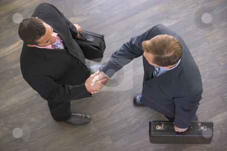 To use this stock image in your creative project, please select the size you need over to the right and click the "Add to Cart" button.
Your downloaded image will come with the Cutcaster watermark removed so don’t worry about the watermark you see on this page. Two businessmen indoors shaking hands stock photo, by Monkey Business Images