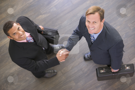 To use this stock image in your creative project, please select the size you need over to the right and click the "Add to Cart" button.
Your downloaded image will come with the Cutcaster watermark removed so don’t worry about the watermark you see on this page. Two businessmen indoors shaking hands smiling stock photo, by Monkey Business Images