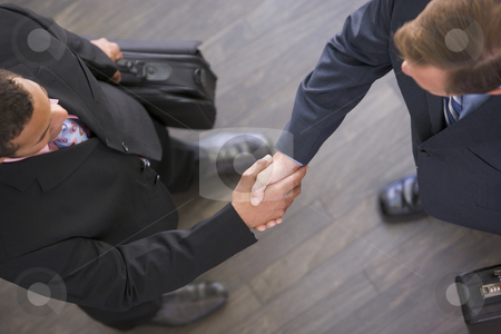 To use this stock image in your creative project, please select the size you need over to the right and click the "Add to Cart" button.
Your downloaded image will come with the Cutcaster watermark removed so don’t worry about the watermark you see on this page. Two businessmen indoors shaking hands stock photo, by Monkey Business Images