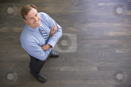 To use this stock image in your creative project, please select the size you need over to the right and click the "Add to Cart" button.
Your downloaded image will come with the Cutcaster watermark removed so don’t worry about the watermark you see on this page. Businessman standing indoors smiling stock photo, by Monkey Business Images