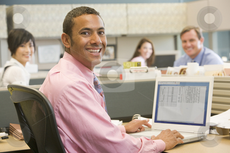 To use this stock image in your creative project, please select the size you need over to the right and click the "Add to Cart" button.
Your downloaded image will come with the Cutcaster watermark removed so don’t worry about the watermark you see on this page. Businessman in cubicle using laptop and smiling stock photo, by Monkey Business Images
