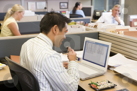 To use this stock image in your creative project, please select the size you need over to the right and click the "Add to Cart" button.
Your downloaded image will come with the Cutcaster watermark removed so don’t worry about the watermark you see on this page. Businessman in cubicle at laptop eating sushi stock photo, by Monkey Business Images