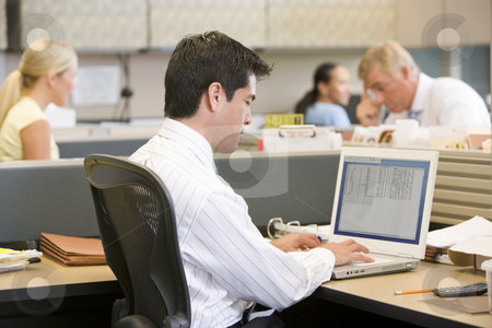 To use this stock image in your creative project, please select the size you need over to the right and click the "Add to Cart" button.
Your downloaded image will come with the Cutcaster watermark removed so don’t worry about the watermark you see on this page. Businessman in cubicle using laptop stock photo, by Monkey Business Images