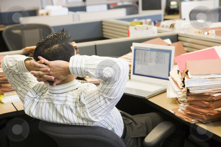 To use this stock image in your creative project, please select the size you need over to the right and click the "Add to Cart" button.
Your downloaded image will come with the Cutcaster watermark removed so don’t worry about the watermark you see on this page. Businessman in cubicle with laptop and stacks of files stock photo, by Monkey Business Images