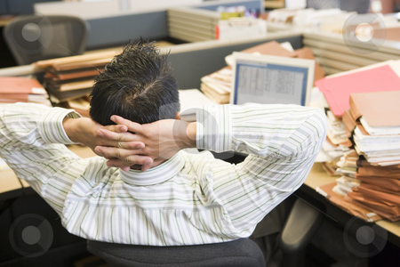 To use this stock image in your creative project, please select the size you need over to the right and click the "Add to Cart" button.
Your downloaded image will come with the Cutcaster watermark removed so don’t worry about the watermark you see on this page. Businessman in cubicle with laptop and stacks of files stock photo, by Monkey Business Images