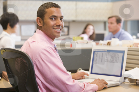 To use this stock image in your creative project, please select the size you need over to the right and click the "Add to Cart" button.
Your downloaded image will come with the Cutcaster watermark removed so don’t worry about the watermark you see on this page. Businessman in cubicle with laptop smiling stock photo, by Monkey Business Images