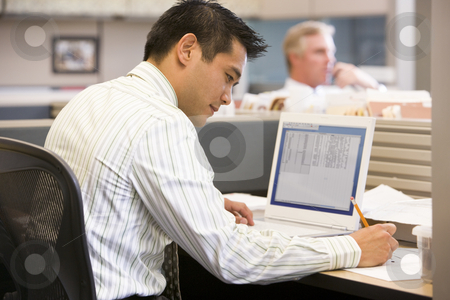 To use this stock image in your creative project, please select the size you need over to the right and click the "Add to Cart" button.
Your downloaded image will come with the Cutcaster watermark removed so don’t worry about the watermark you see on this page. Businessman in cubicle with laptop writing stock photo, by Monkey Business Images