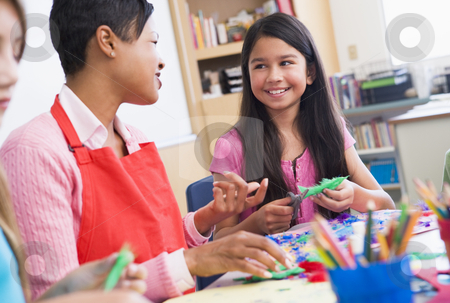 To use this stock image in your creative project, please select the size you need over to the right and click the "Add to Cart" button.
Your downloaded image will come with the Cutcaster watermark removed so don’t worry about the watermark you see on this page. Elementary school art class stock photo, Elementary school art class with teacher by Monkey Business Images
